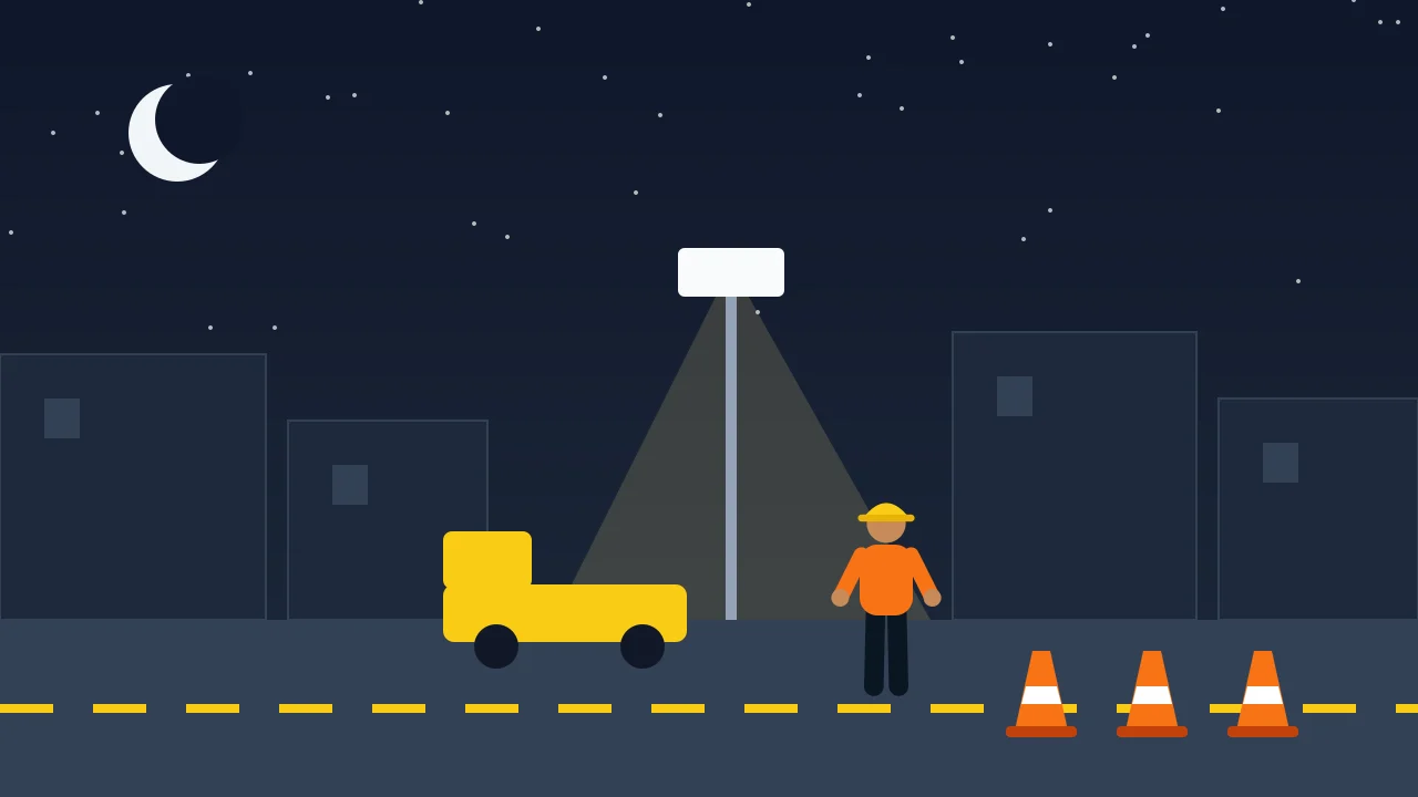 A night work crew on a street under a light tower with cones